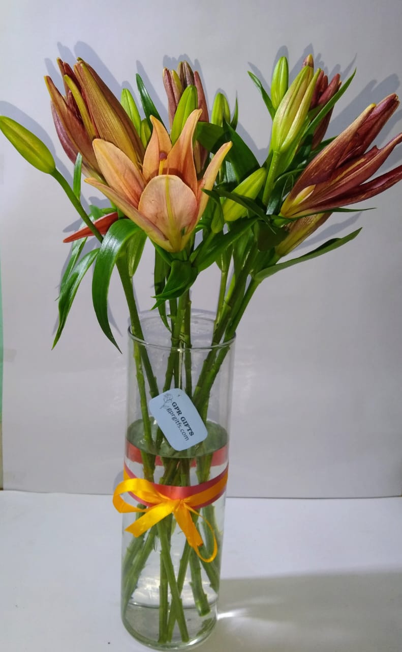 This sweet arrangement contains a collection of seven freshly handpicked red lilies.